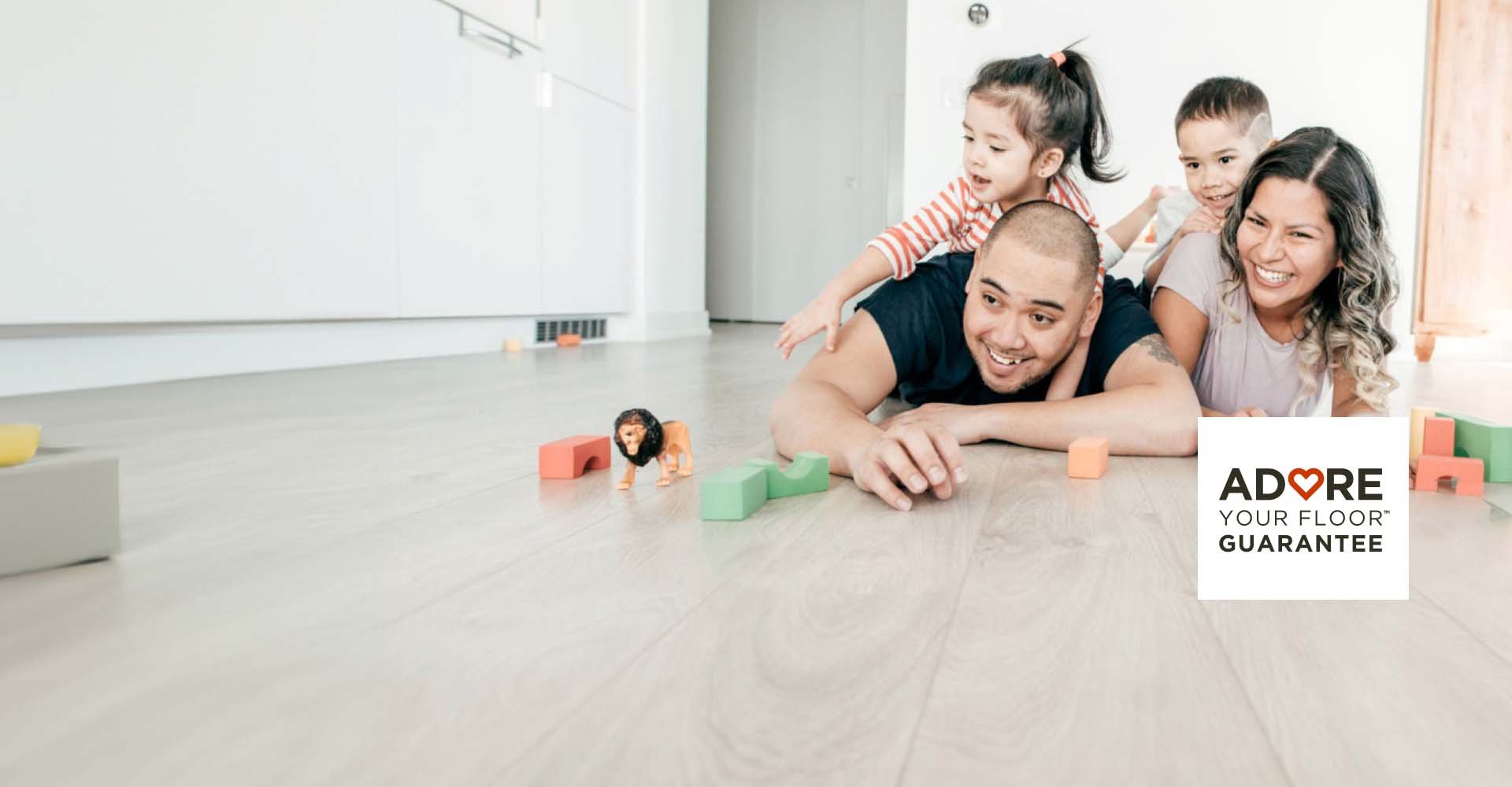 Family Laying on Hard Surface Flooring with Toys