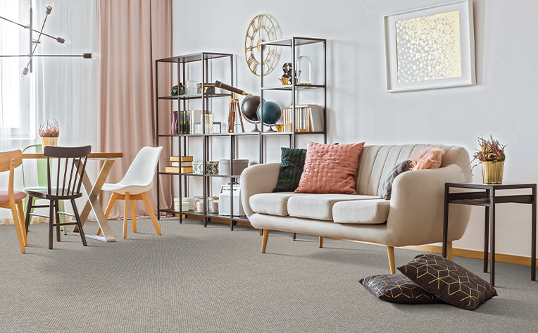 grey carpet in living room with small table